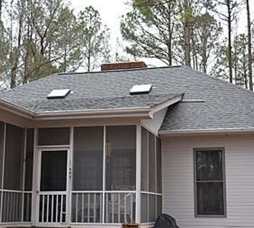 A shingle porch roof with sunlights by the roofers at Housetop Roofing & Home Improvement in Wake Forest, NC.