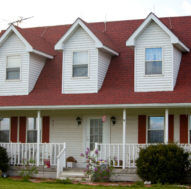 A house with a red shingle roof and dormers reshingled by the roofers at Housetop Roofing & Home Improvements in Wake Forest, NC.