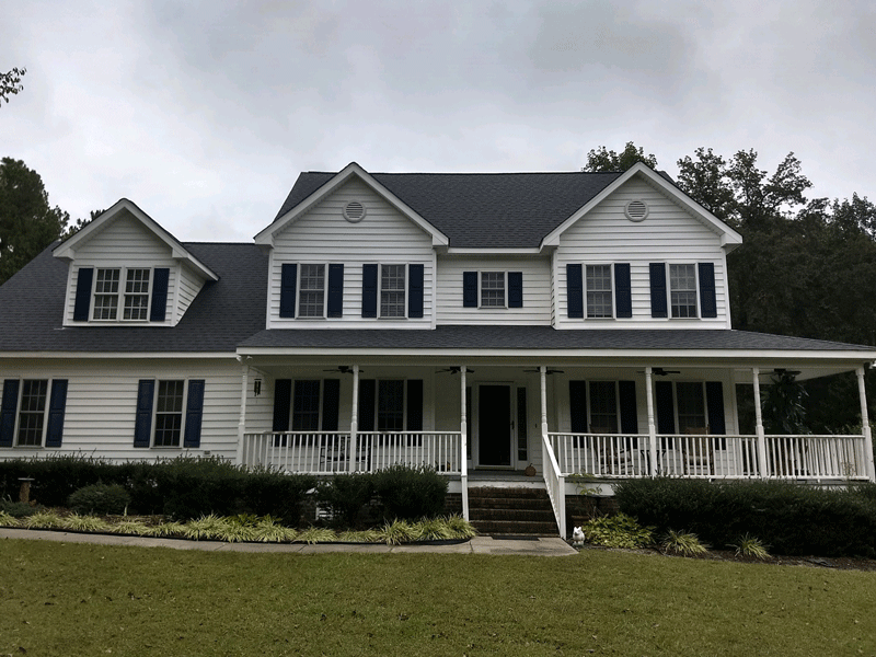 A white home with new roofing in Wake Forest, NC by Housetop Roofing & Home Improvements