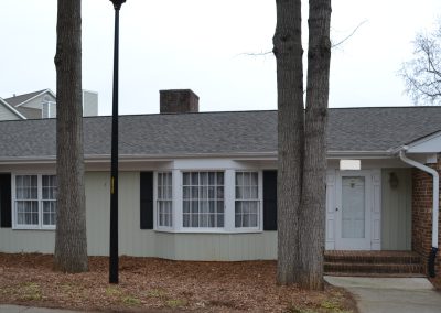 Brick and siding ranch home with a bay window and a new gray architectural shingle roof.