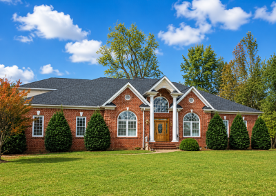 Brick ranch home with a white columned entry and a new charcoal architectural shingle roof.