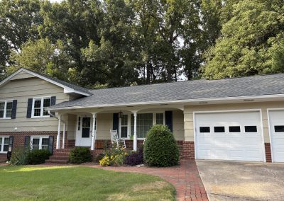 Split-level home with an attached garage and a new gray architectural shingle roof.