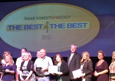 Local business winners, including Housetop Roofing, on stage at the Wake Forest Weekly Best of the Best 2015 awards.